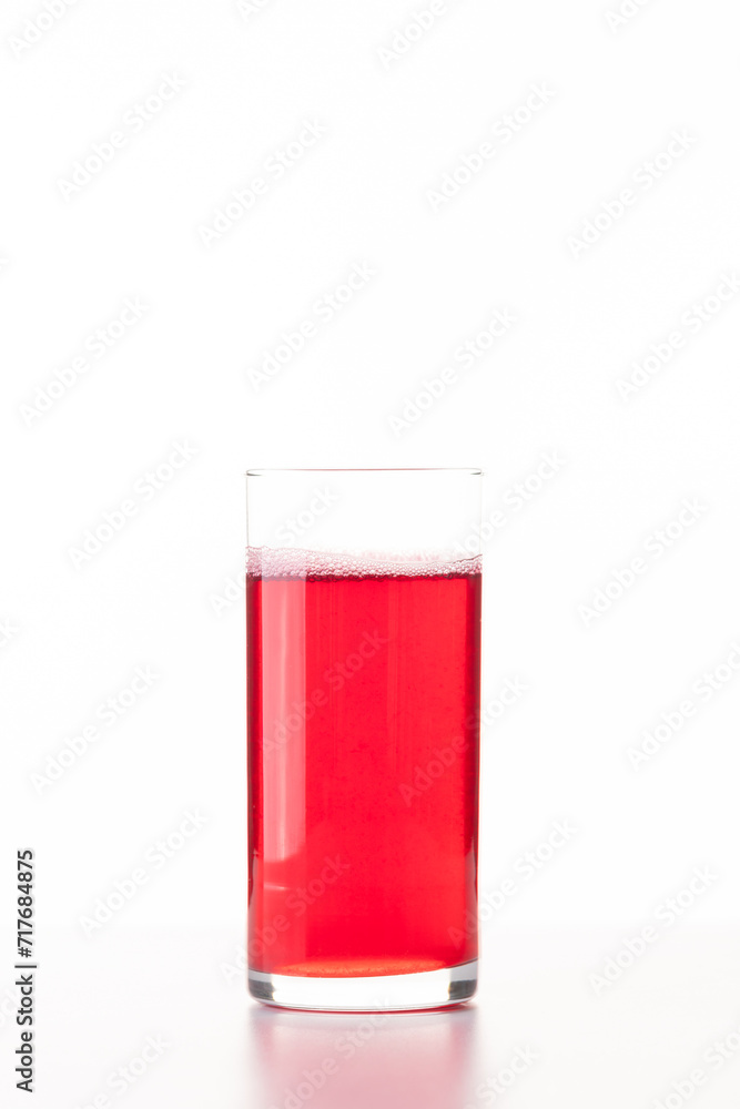 Business lunch. Berry juice in a glass on a white background Business lunch. Berry juice in a glass on a white background