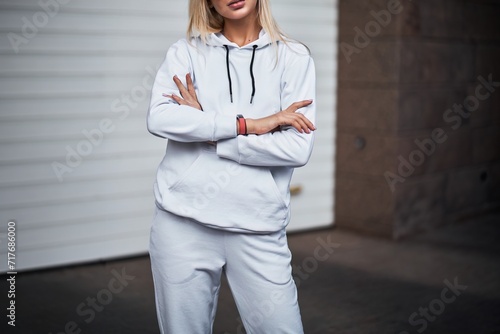 Young girl wears a white hoodie. Outdoor closing mock-up for logo and branding.