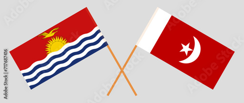 Crossed flags of Kiribati and The Emirate of Umm Al Quwain. Official colors. Correct proportion photo