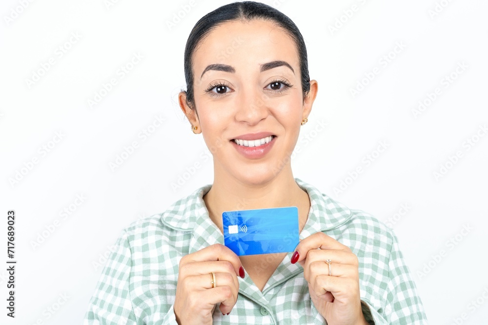 Photo of Beautiful young woman wearing green plaid pyjama and holding a cup positive smile hold credit card income salary Photo of Beautiful young woman wearing green plaid pyjama and holding a cup positive smile hold credit card income salary