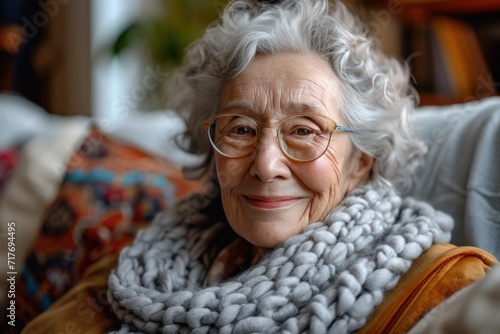 elderly woman smiling while sitting on couch