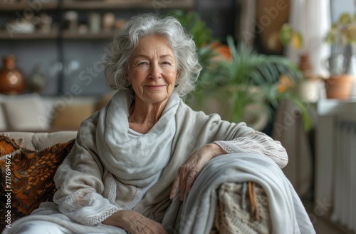 elderly retired woman sitting on couch while smiling