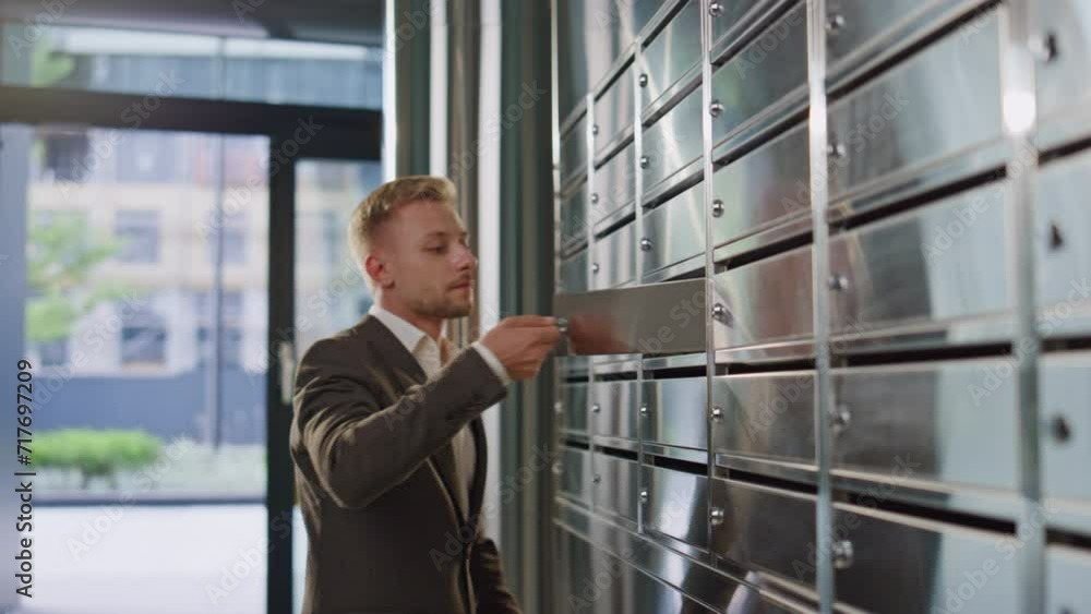 Man open private mailbox checking correspondence closeup. Upset guy look letter Man open private mailbox checking correspondence closeup. Upset guy look letter