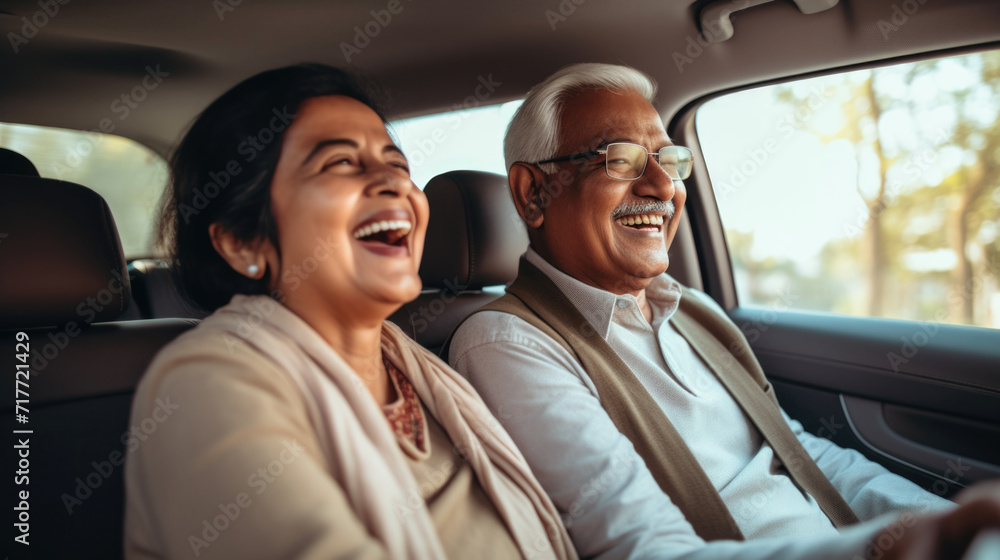 Happy senior couple of Indian ethnicity sitting inside a car and enjoying the trip Happy senior couple of Indian ethnicity sitting inside a car and enjoying the trip