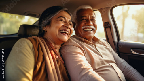 Happy senior couple of Indian ethnicity sitting inside a car and enjoying the trip