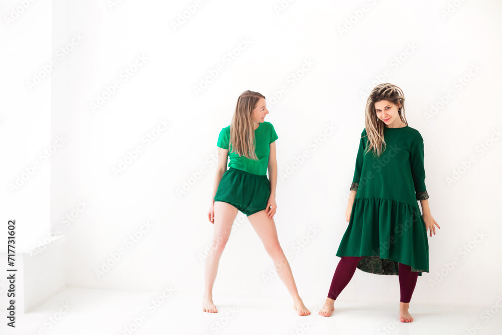 Two young women doing yoga indoo Two young women doing yoga indoo