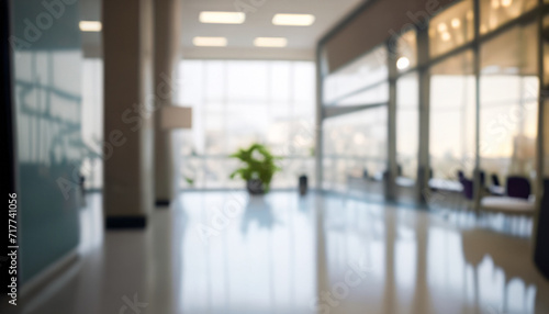 Blurred hotel or office building lobby blur background interior view toward reception hall  modern luxury white room space with blurry corridor and building glass wall window