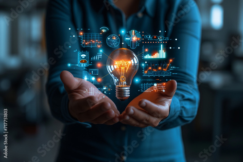 A Businessman Holding a Creative Light Bulb Accompanied by Growth Graph and Analytics Icons - Utilizing Analytics Technology to Develop New Strategies and Insights for Enhanced Performance 