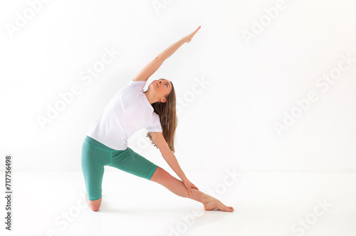 Flexible woman doing yoga at home