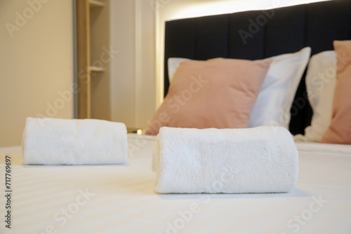 Clean towels on bed in modern interior bedroom 