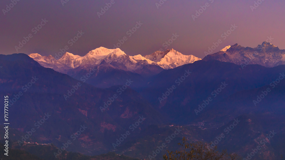 A view of Snow clad Kangchenjunga, also spelled Kanchenjunga,the third highest mountain in the world, at the time of Sunrise.