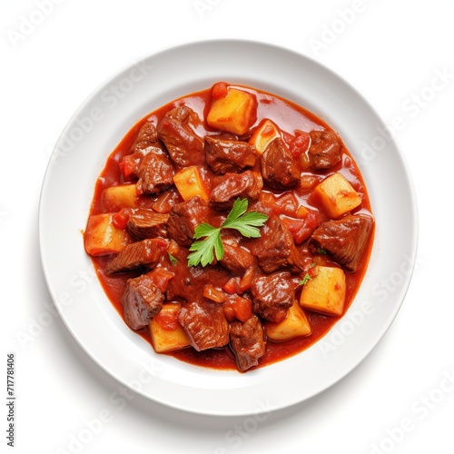 A plate with Goulash on a white plate top view isolated on a white background