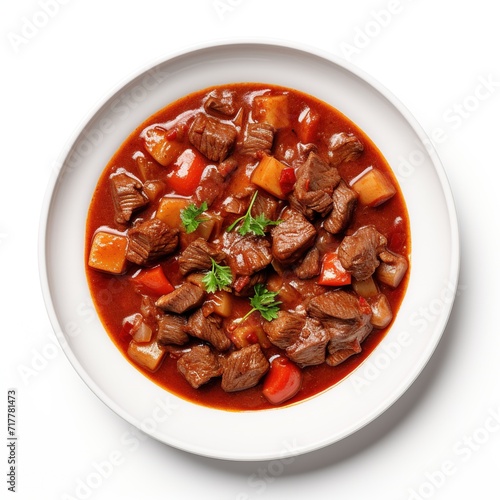 A plate with Goulash on a white plate top view isolated on a white background