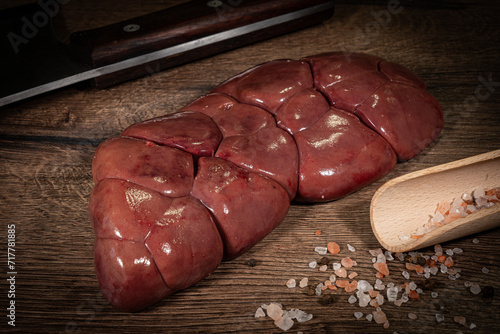Canvastavla Raw Beef kidney, fresh sliced offal meat on plate