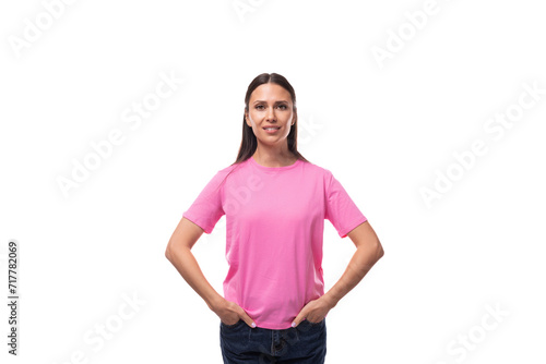 young slim caucasian brunette woman in a pink t-shirt on a white background with copy space © Ivan Traimak