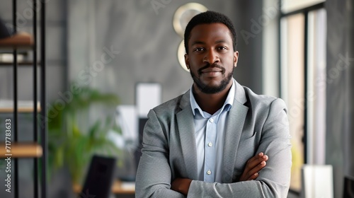 confident black businessman in office looking at camera