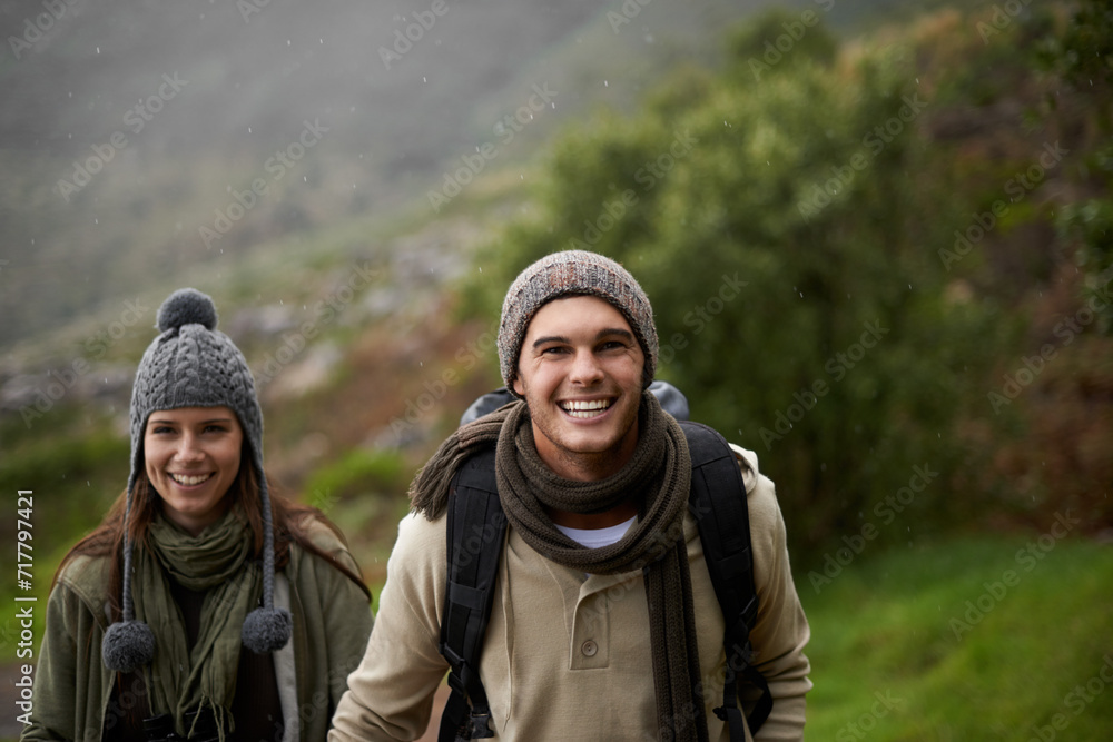 Portrait, hiking and happy with couple, tourist and walking with backpack, mountain and bonding together. Outdoor journey, adventure and trekking in path, field and exercise for fitness and travel