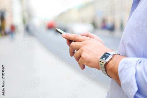Man using mobile phone in city