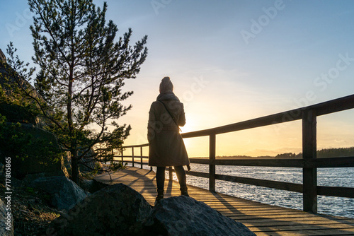 Blonde girl on the deck in sunset in mariehamn in aland islands