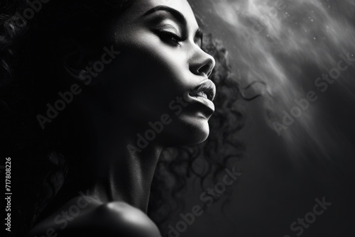 Black and white side portrait of a beautiful woman with the play of light and shadows