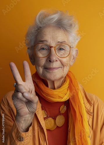 senior woman with glasses giving a victory sign senior woman