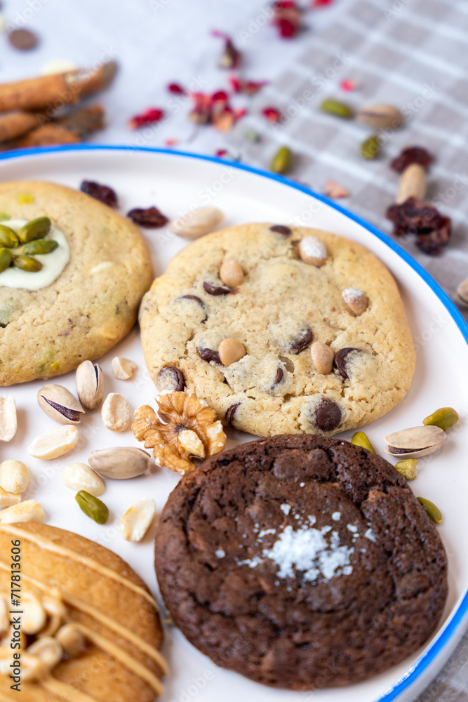 Fototapeta premium Hazelnut, chocolate and pistachio cookies served on a ceramic tray