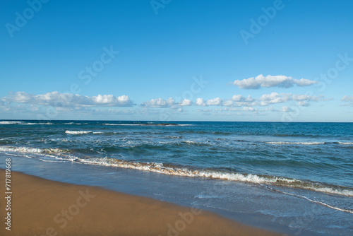 Cyprus Alagadi Turtle Beach. View from the beach to the sea. Magnificent beach, sea and blue cloudy sky.