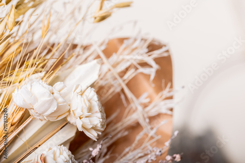 A charming bohemian-inspired bouquet featuring an array of dried flowers, delicately arranged against a soft, light backdrop, evoking a sense of rustic elegance and natural beauty.