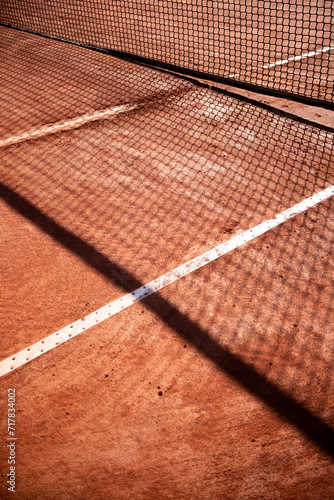 Net Shadow on clay court, sports event concept photo