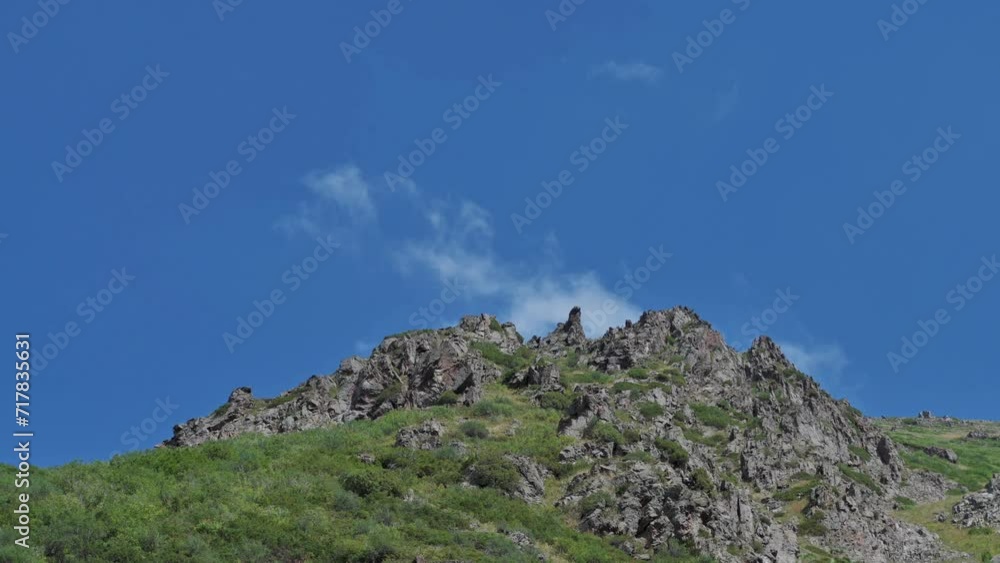 Tien Shan mountains in summer under a blue sky with clouds Tien Shan mountains in summer under a blue sky with clouds