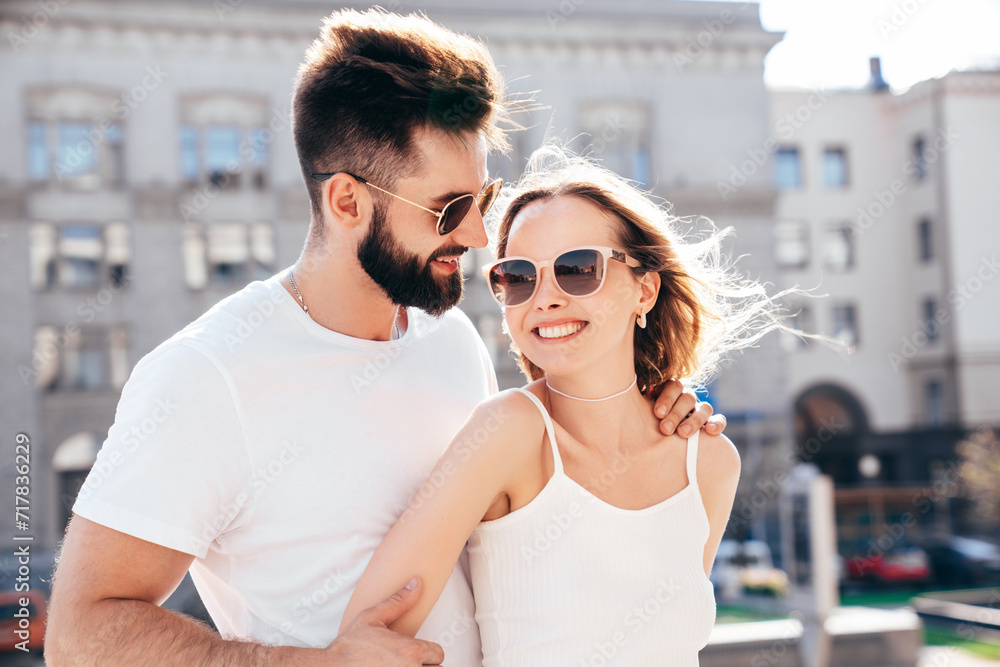 Smiling beautiful woman and her handsome boyfriend. Woman in casual summer clothes. Happy cheerful family. Female having fun. Couple posing in street at sunny day. Having tender moments. In sunglasses Smiling beautiful woman and her handsome boyfriend. Woman in casual summer clothes. Happy cheerful family. Female having fun. Couple posing in street at sunny day. Having tender moments. In sunglasses