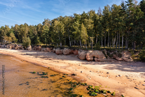Baltic Sea coast with sandy beach and red sandstone cliffs, Veczemju cliffs, Latvia photo