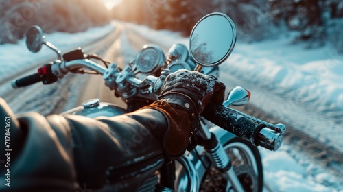 Hand in glove on motorcycle handlebar in winter, free space for insertion photo