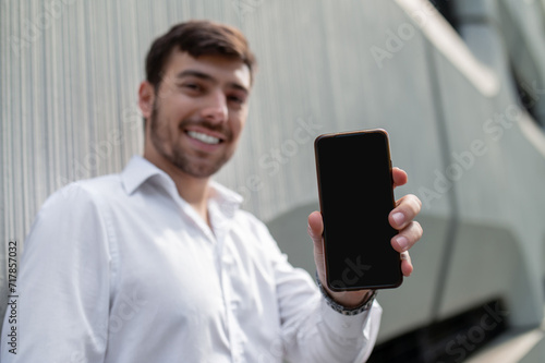 Young elegant man with a phone in hands