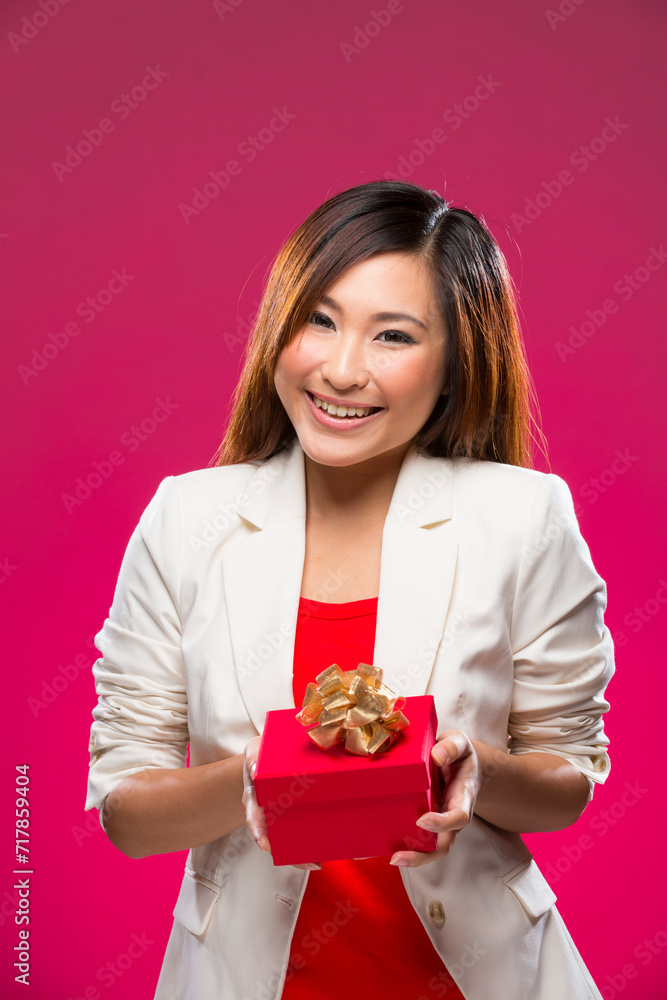 Happy Chinese woman holding a christmas gift. Happy Chinese woman holding a christmas gift.