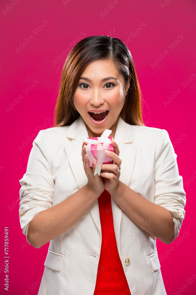 Happy Chinese woman holding a christmas gift. Happy Chinese woman holding a christmas gift.