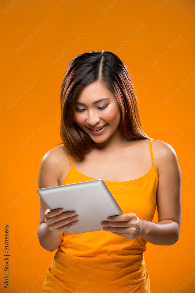 Happy Chinese Woman using a digital tablet. Happy Chinese Woman using a digital tablet.