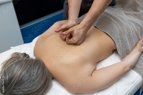 Close up of female patient having back massage in a clinic