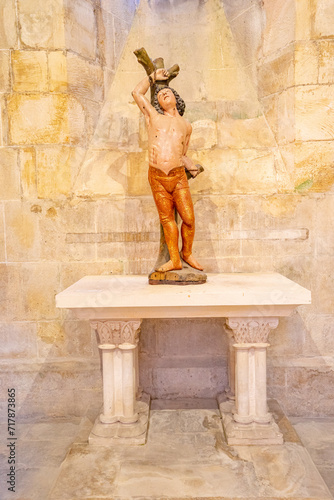 figure representing Christ in polychrome wood and upholstered inside the cloisters of the Batalha monastery. photo