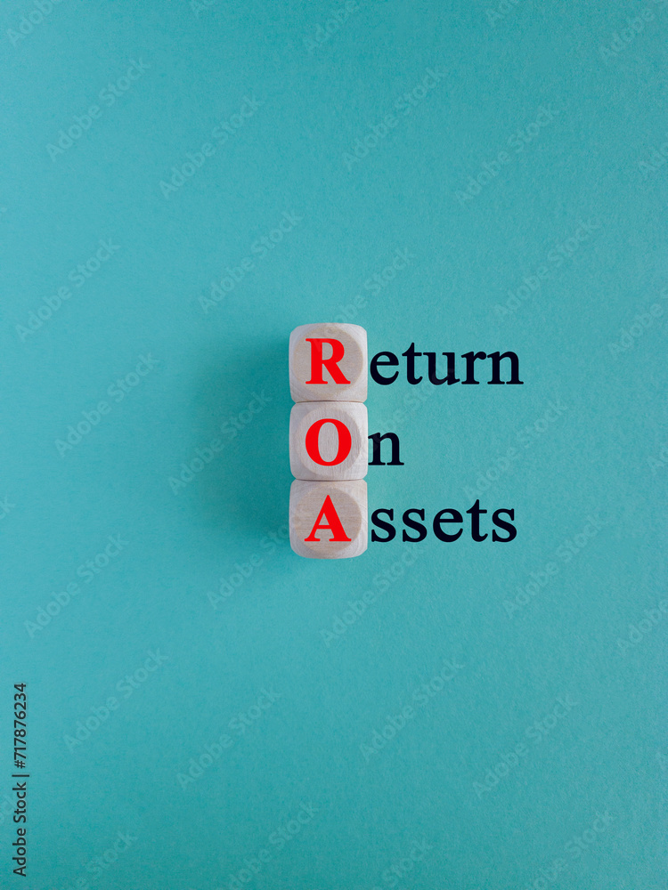 Return on assets symbol. Wooden cubes with the red inscription return on assets on beautiful blue background. Business concept. Return on assets symbol. Wooden cubes with the red inscription return on assets on beautiful blue background. Business concept.