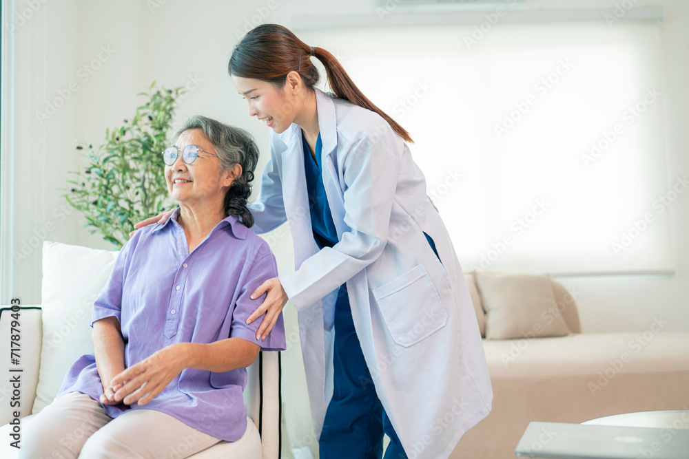 Asian female doctor taking care and talking mature female patient sitting on sofa in hospital. Healthcare concept. Asian female doctor taking care and talking mature female patient sitting on sofa in hospital. Healthcare concept.