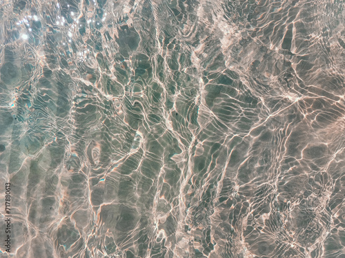 Blue water surface viewed from above in outdoor sea, sun reflection, dimply. Surface Abstract Background. Clear water in sea with ripple in clean aqua liquid. Summer wallpaper blue background