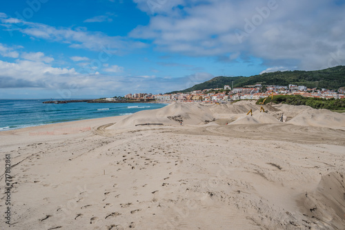 Machines under construction on the dune of Praia da Duna do Caldeir  o with the architecture of Vila Praia de   ncora in the background  PORTUGAL