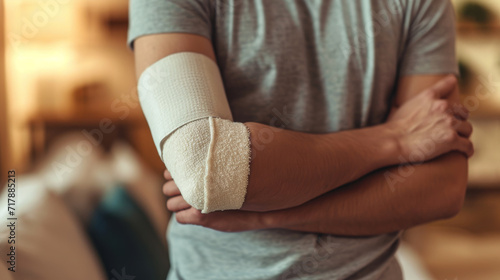 an individual with a bandaged arm seemingly in discomfort or in the process of self-examination photo