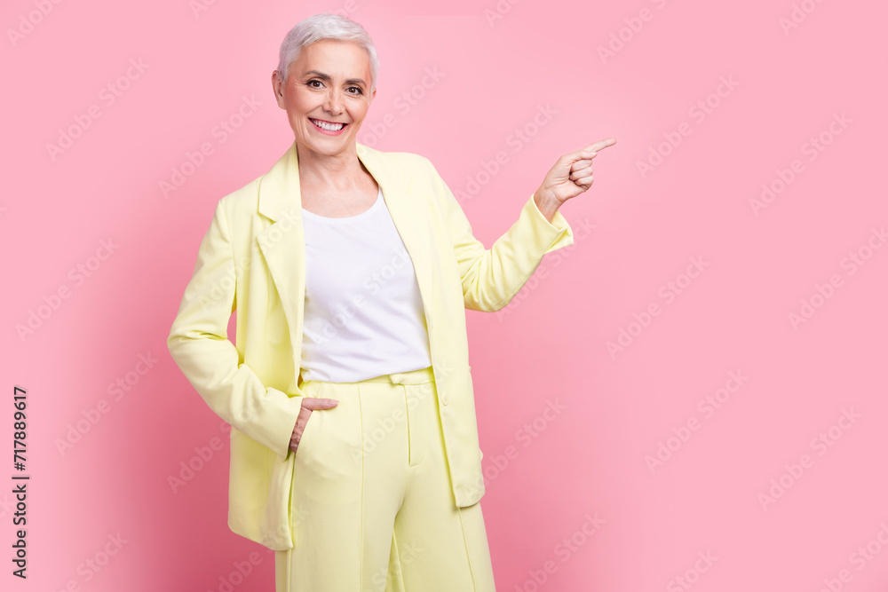 Portrait of entrepreneur lady in yellow suit direct finger empty space invite business training school isolated on pink color background Portrait of entrepreneur lady in yellow suit direct finger empty space invite business training school isolated on pink color background