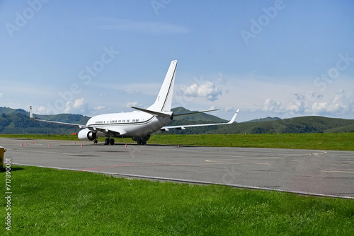 large passenger plane was taxiing for take-off in summer