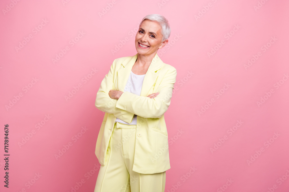 Photo of cool optimization operations manager experienced mature woman folded hands wear yellow suit isolated on pink color background Photo of cool optimization operations manager experienced mature woman folded hands wear yellow suit isolated on pink color background