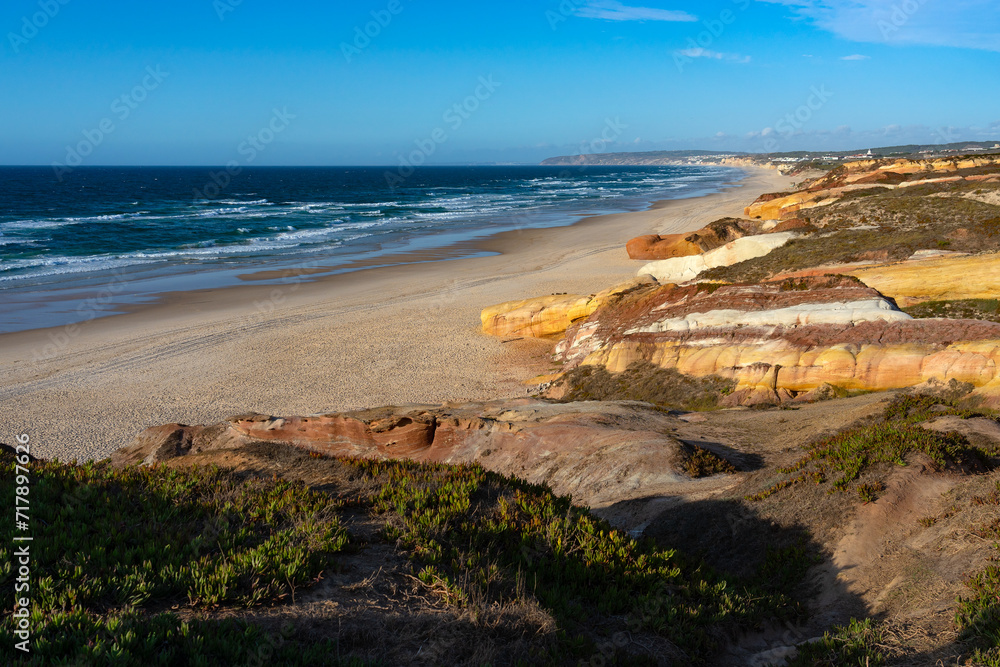 Almagreira beach in the Peniche area with the multicolored sandstone rocks in the Center region of Portugal, at sunset.