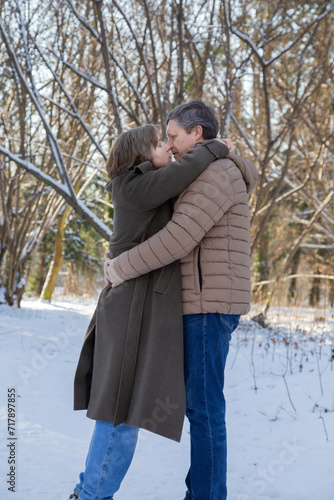 happy couple in winter snowy park © Maya Kruchancova
