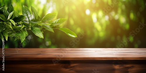 Empty wooden table against a background of plants in blur. Concept template for presentation of products  cosmetics  drinks  etc. Copyspace layout